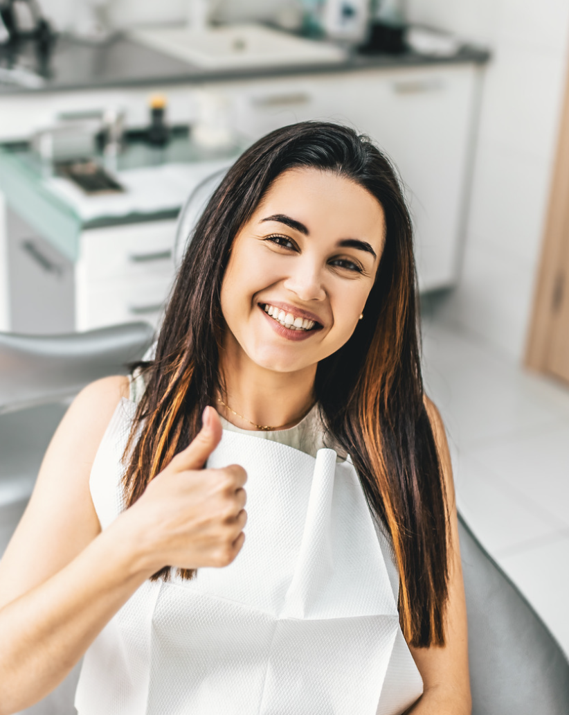 A happy lady smiling after receiving emergency dental care at Dentin Family Dentistry in Vaughan, showcasing relief and satisfaction with our prompt and professional service